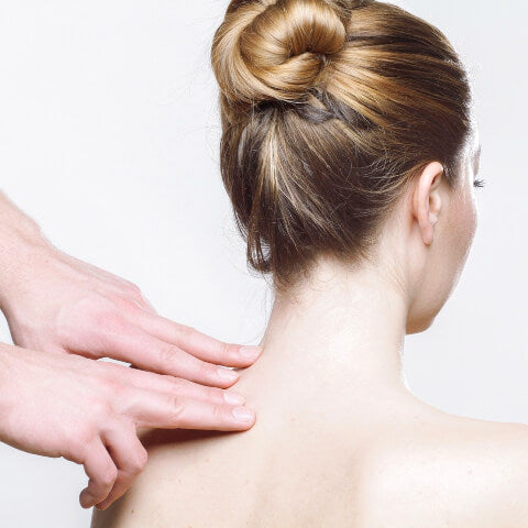 Woman having neck massaged
