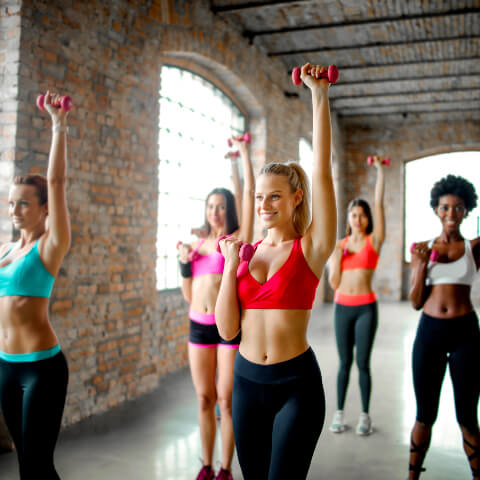 A group of women taking part in aerobic exercises with probiotic deodorants on