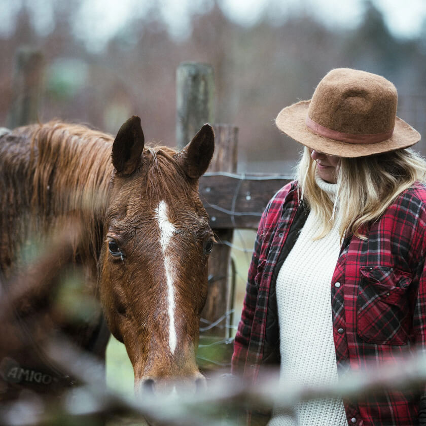 Lady and her horse in a corral